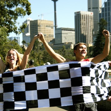 Classic Amazing Race Winners Crossing Finish Line Chequered Flag Sydney